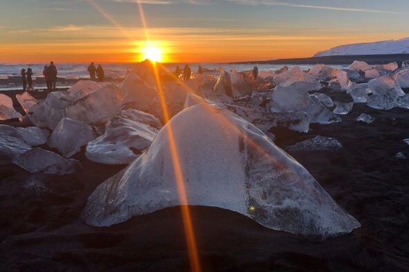 Black Diamond Beach in Iceland with the sun setting over the sea