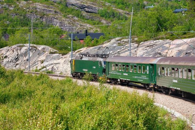 Flam railway running in the mountains in the summer time