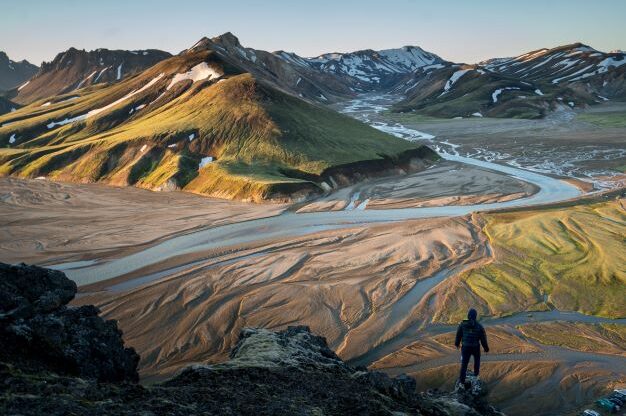 Vulcano landscape in Iceland with a man looking over it