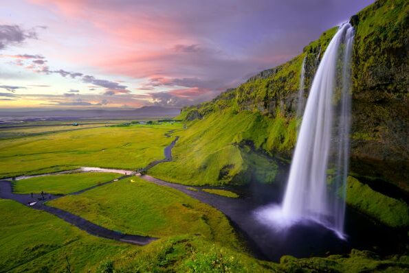 Landscape of a green valley with a waterfall