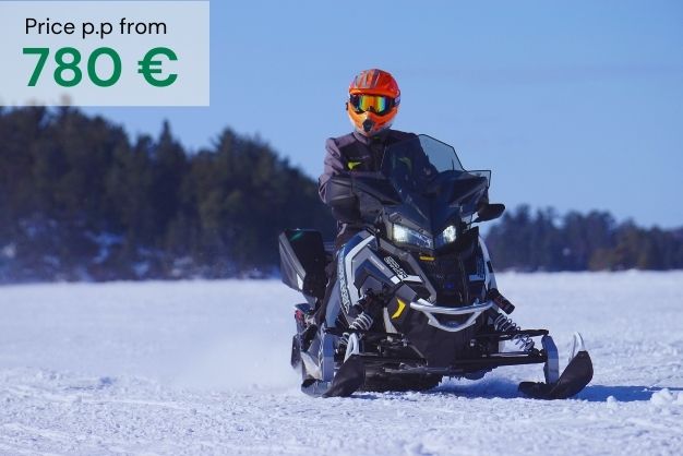 Man on snow mobile on crisp snow with blue sky. Image as an introduction of "Winter Magic in rovaniemi´´ tour. Price per person 780€