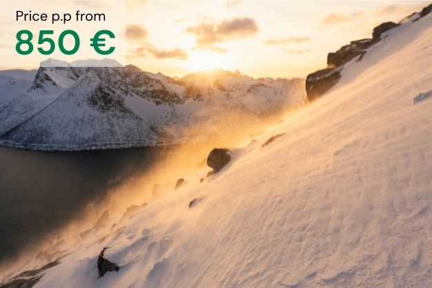 Fjords and mountains with the sun setting over snow covered landscape as a presentation of "Fjords in winter colors" tour. Price per person from 850€