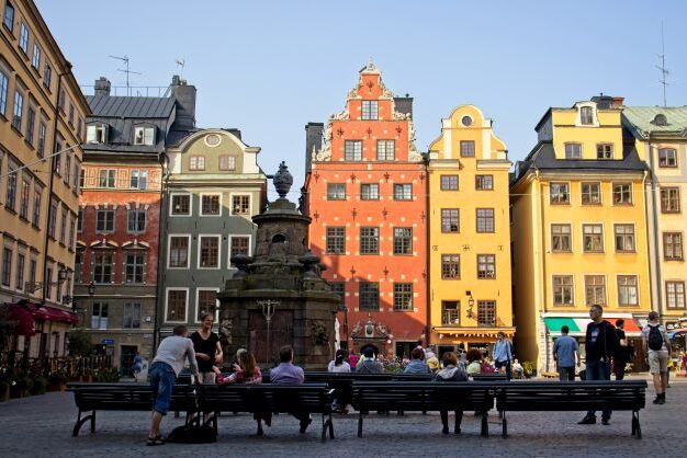 People sitting on a central square in gamla stan of stockholm